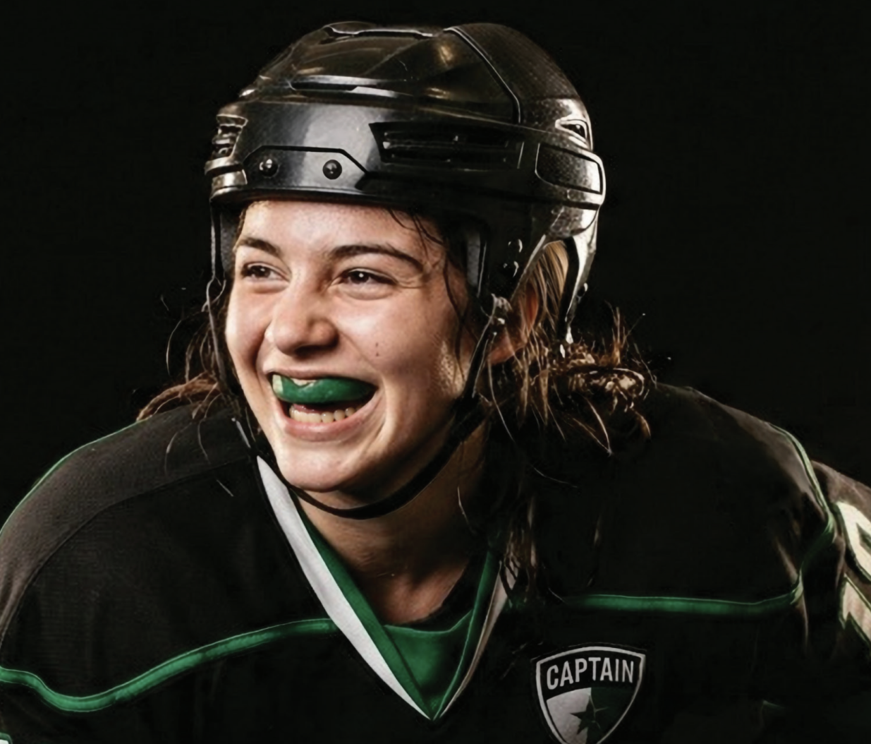 Female hockey player wearing Delta Dental mouthguard.