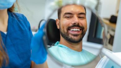 Man looking in mirror at dentist